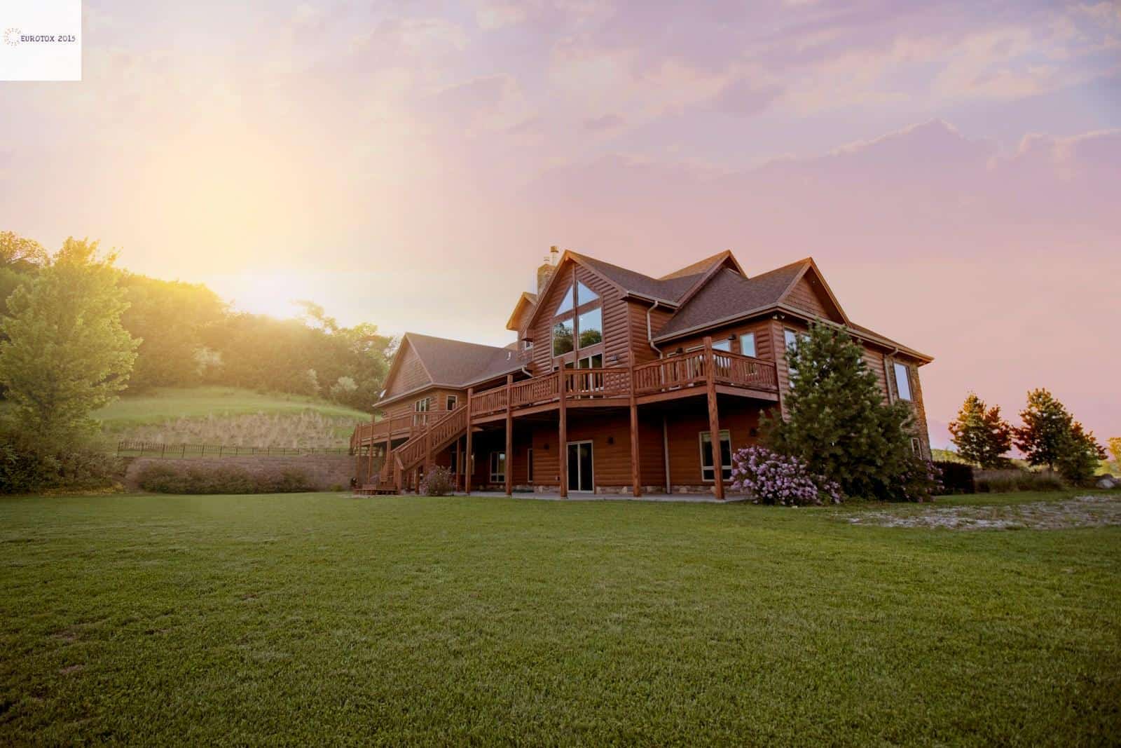 brown wooden house with green grass field