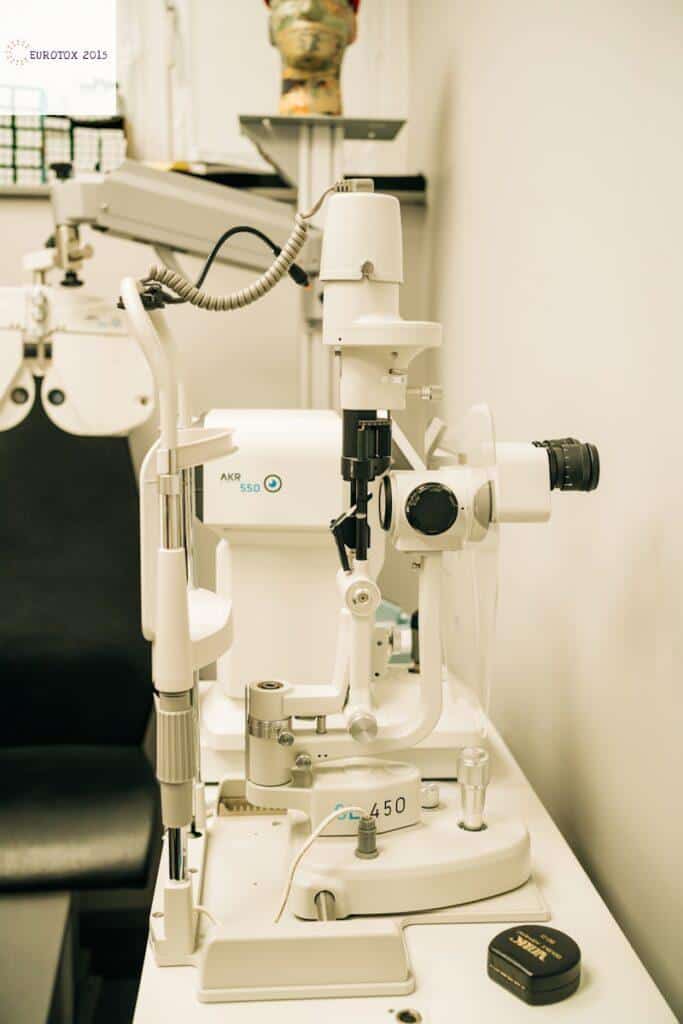 a microscope sitting on top of a table next to a black chair
